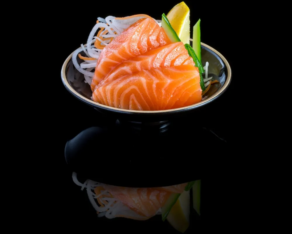 Thick fresh salmon sashimi with garnish at Kendo Sushi, a Japanese Restaurant in Philadelphia.